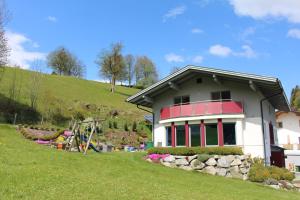 a house on top of a grassy hill at Haus Lorenz in Schladming
