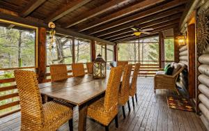 a dining room with a wooden table and chairs at Pop A Bear in Pittman Center