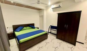 a bedroom with a bed with blue and green pillows at Ocean Pearl Dream Villa Matara in Matara +29 photos