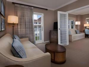 a living room with a white couch and a table at Disney's Beach Club Resort in Orlando