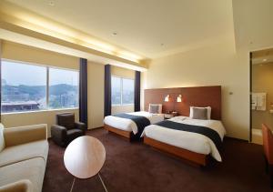 Postel nebo postele na pokoji v ubytování Oriental Hotel Hiroshima