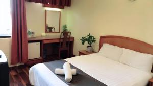 Postel nebo postele na pokoji v ubytování Global Hotel Labuan