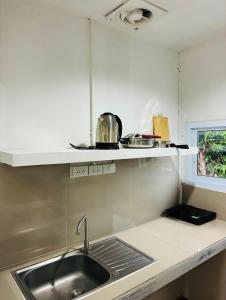 a kitchen with a sink and a counter top at Chaweng Eco Parc in Ban Ko Khwan