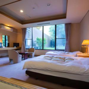 Llit o llits en una habitació de Yufuin Onsen Yufuin Nanairo no Kaze