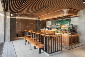 a restaurant with a bar with chairs and a counter at PHUC LONG LUXURY Hotel Danang in Danang +50 photos