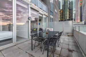 a black table and chairs on a balcony at 'Swanston Central' Wellness-infused City Living in Melbourne
