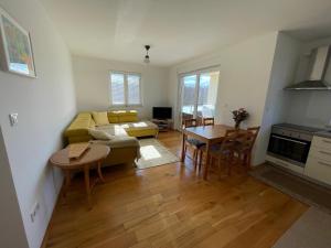 a living room with a couch and a table at Apartman Damir in Malinska +6 photos