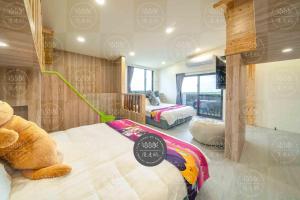 a bedroom with two beds and a teddy bear at Lanyang Beach Villa in Wujie