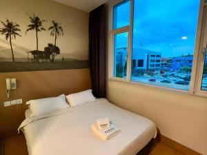 a hotel room with a bed with a window at D Arc Hotel in Penampang +115 photos