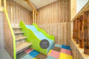 a staircase in a room with a green slide at Lanyang Beach Villa in Wujie