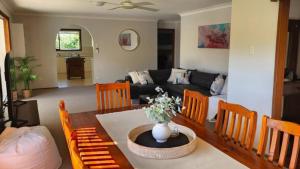 a living room with a table and a couch at A Slice Of Paradise in Sussex Inlet