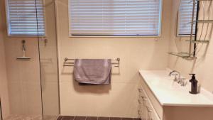 a bathroom with a sink and a shower at A Slice Of Paradise in Sussex Inlet