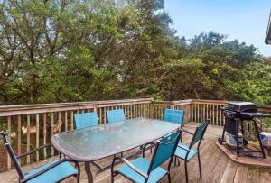 a table and chairs on a deck with a grill at 1714 - Destiny in Poplar Branch