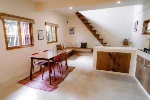 a living room with a table and a couch at Surfer's Hideout - central two-storey HOUSE with garden & private balcony in General Luna