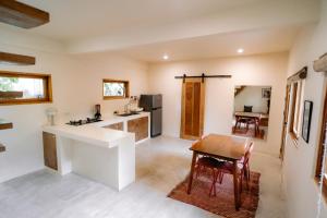 a kitchen and dining room with a table and chairs at Surfer's Hideout - central two-storey HOUSE with garden & private balcony in General Luna +23 photos