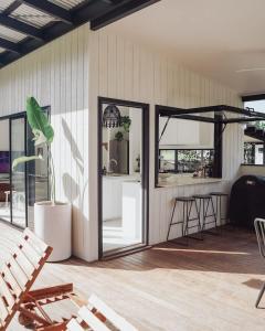 a patio with a bar and a table and chairs at The slow monday - Modern Beach Shack in Mission Beach