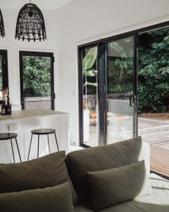 a living room with a couch and a kitchen at The slow monday - Modern Beach Shack in Mission Beach +11 photos