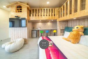 a teddy bear sitting on a bed in a bedroom at Lanyang Beach Villa in Wujie