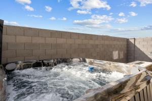 a hot tub with water in a brick wall at Adventure Basecamp townhouse in Washington