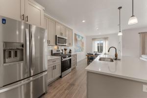 a kitchen with stainless steel appliances and white cabinets at Adventure Basecamp townhouse in Washington