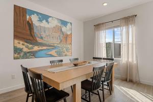 a dining room with a large painting on the wall at Adventure Basecamp townhouse in Washington