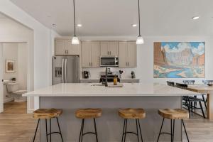 a kitchen with a large white island with bar stools at Adventure Basecamp townhouse in Washington +50 photos