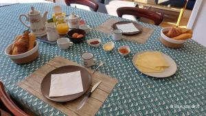a table with plates of food and eggs and bread at Belle Echappée Mosane in Waulsort