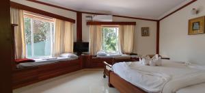 Postel nebo postele na pokoji v ubytování Sunset Beach Resort