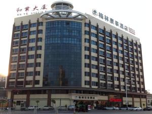 a large building with a sign on top of it at GreenTree Inn Shantou Chengjiang Road Business Hotel in Xialian