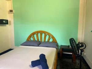 a bedroom with a bed with a blue tie on it at VaoVao Hotel in Nosy Be