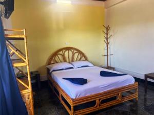 a bedroom with a bed with a ladder in it at VaoVao Hotel in Nosy Be