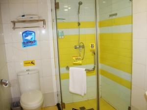 a bathroom with a toilet and a glass shower at 7 Days Inn Wuhan Hanyang Wanda Plaza in Wuhan +51 photos