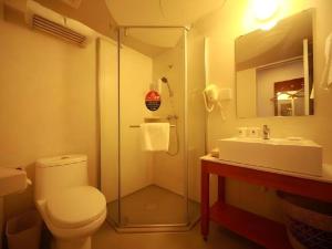 a bathroom with a shower and a toilet and a sink at GreenTree Inn Anhui Suzhou Baima Mall Express Hotel in Suzhou