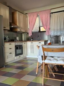 a kitchen with a checkered floor and a table and chairs at AEGEAN view ! in Kavála
