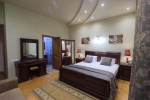 a bedroom with a bed and a mirror at Marys Family Guest House in Yerevan +32 photos