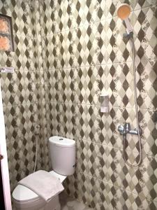 a bathroom with a toilet and a shower at Prime Adisucipto Hotel in Kalasan +20 photos