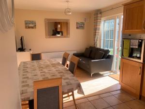 a living room with a table and a couch at 39 woodview in Listowel