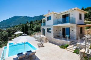 a villa with a swimming pool and a house at Diamanti Villas in Nikiana