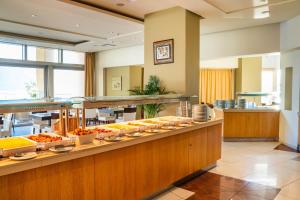 a buffet line with food on display in a restaurant at Konstantinos Palace in Karpathos
