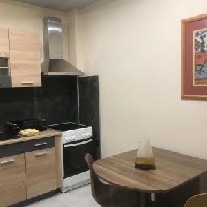a kitchen with a table and a stove top oven at Διαμέρισμα στο κέντρο της πόλης in Thiva +7 photos