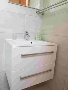 a bathroom with a white sink and a mirror at Studio Apartment Sanja 1 in Neum