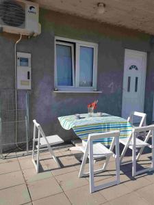 a table and two chairs sitting next to a building at Studio Apartment Sanja 1 in Neum