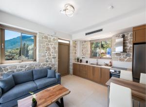 a living room with a blue couch and a stone wall at Diamanti Villas in Nikiana