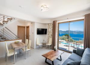 a living room with a blue couch and a table at Diamanti Villas in Nikiana
