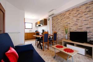 a living room with a couch and a table with chairs at House and Apartments in Labin 8758 in Labin