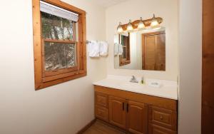 a bathroom with a sink and a mirror and a window at Brink of Paradise in Gatlinburg +30 photos