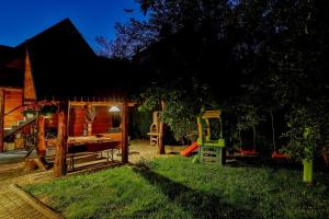 a backyard with a playground and a house at Domek i Pokoje z widokiem na Tatry - U Magdy Zakopane in Zakopane