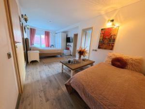 a bedroom with a bed and a living room at Casa Adriana in Eforie Sud