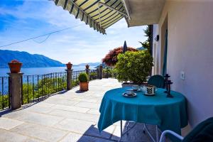 a table on a patio with a view of the water at Casa Balon in Oggebio