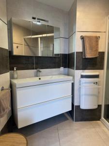 a bathroom with a white sink and a mirror at La Grande Tour in Valras-Plage +27 photos